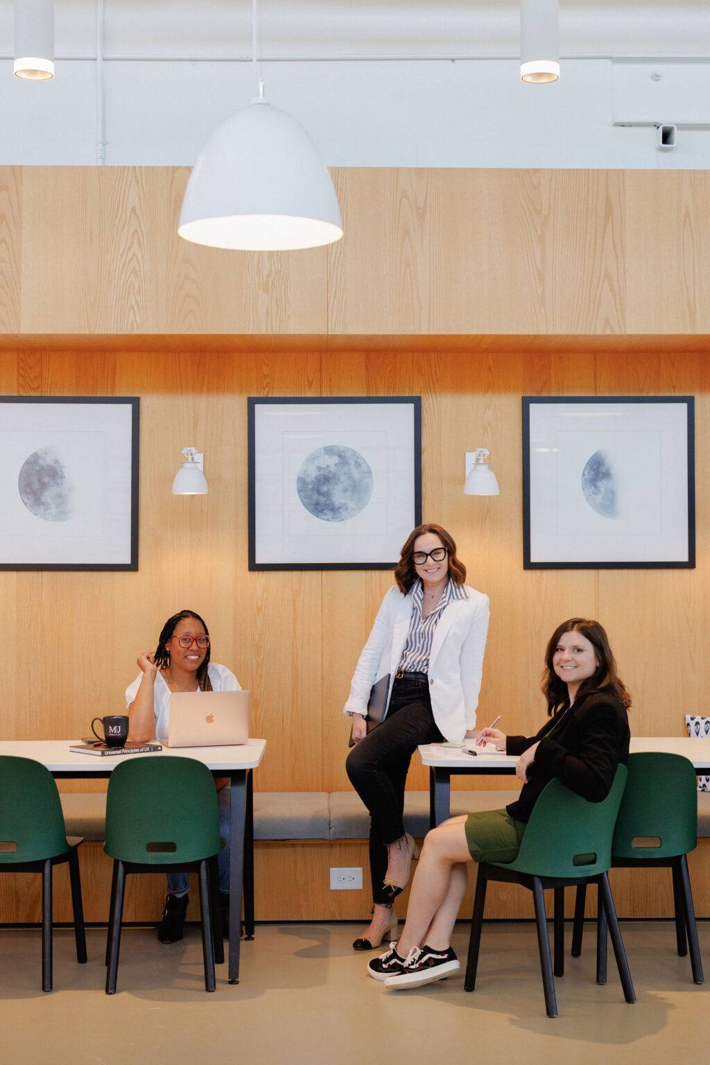 Three MJC team members in a modern web design office setting.