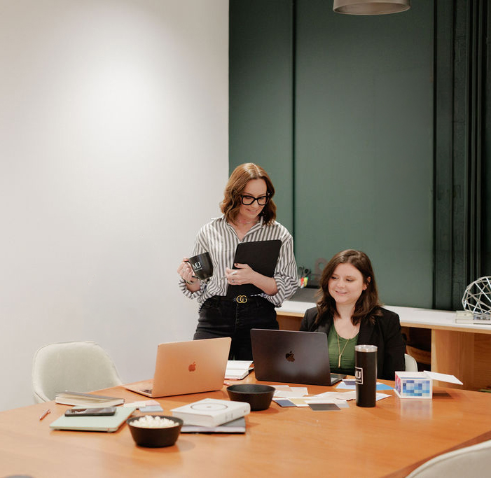 Two marketing agency owners working together in modern web design office